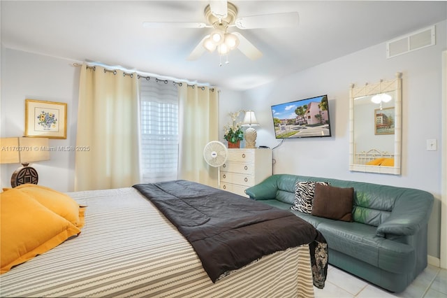 bedroom featuring tile patterned floors, visible vents, and ceiling fan