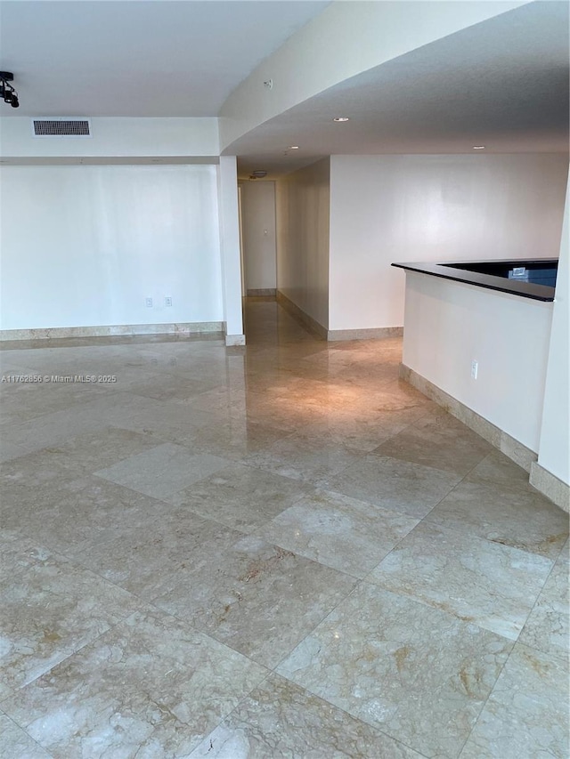 empty room with baseboards and visible vents