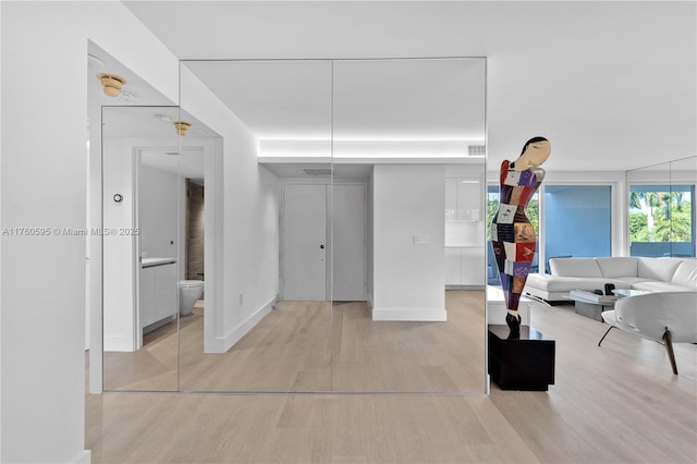 living room featuring light wood-type flooring and baseboards