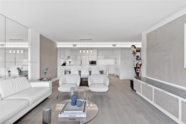 living area featuring visible vents and light wood-type flooring