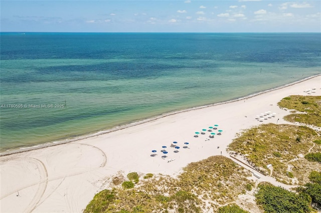 birds eye view of property featuring a view of the beach and a water view