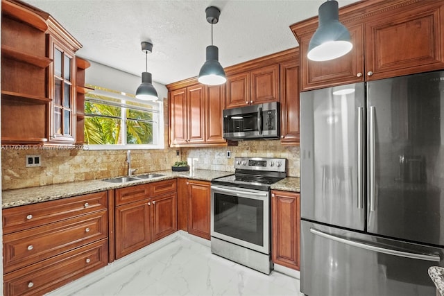 kitchen featuring marble finish floor, light stone countertops, stainless steel appliances, and a sink