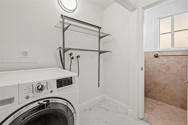 washroom featuring laundry area, washer / dryer, marble finish floor, and baseboards