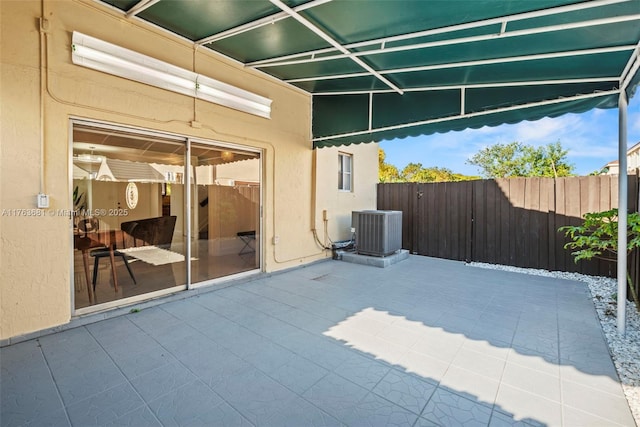 view of patio with central AC and fence