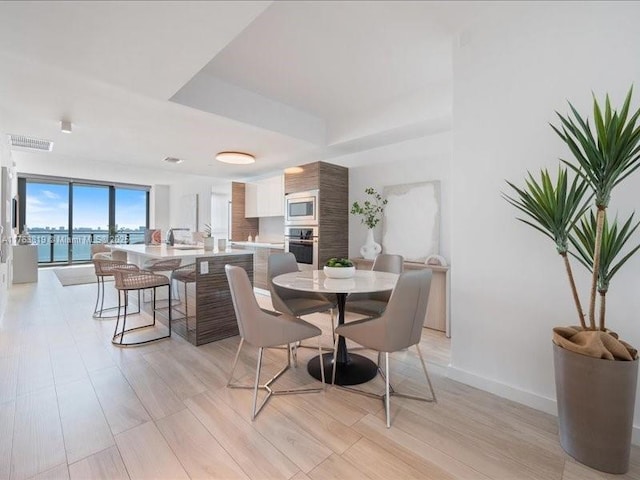 dining space featuring baseboards and visible vents