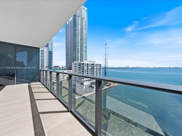 balcony with a water view and a city view