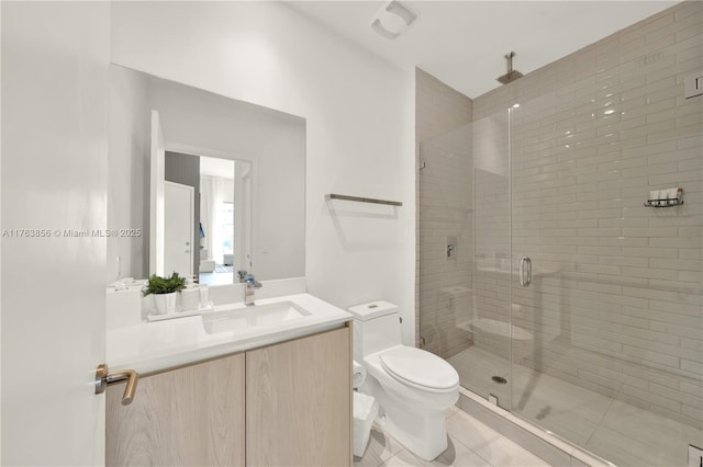 bathroom featuring tile patterned floors, toilet, a stall shower, and vanity