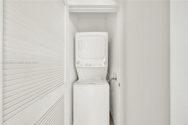 laundry room featuring laundry area and stacked washer / drying machine