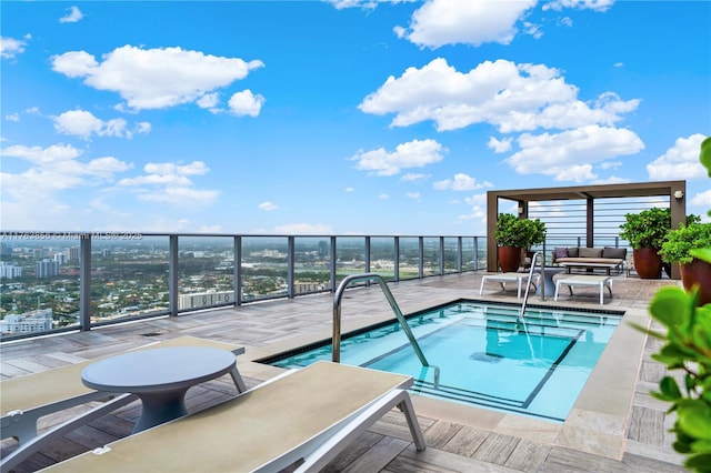 view of swimming pool featuring a patio, a community hot tub, and an outdoor hangout area