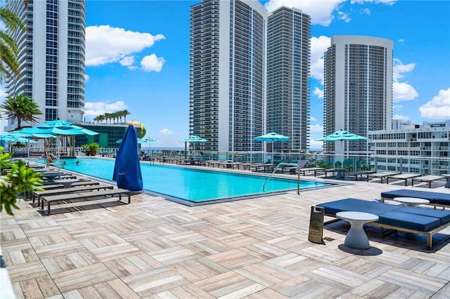 pool with a view of city and a patio area