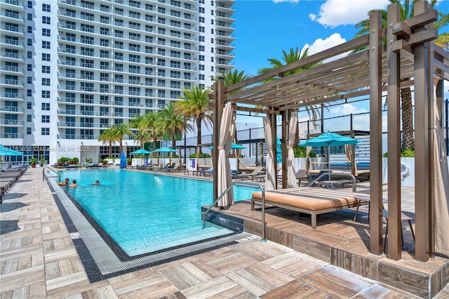 community pool with a pergola and a patio