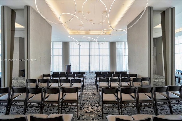 dining room with floor to ceiling windows and a tray ceiling