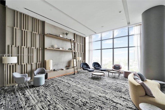 carpeted living room featuring a high ceiling and expansive windows