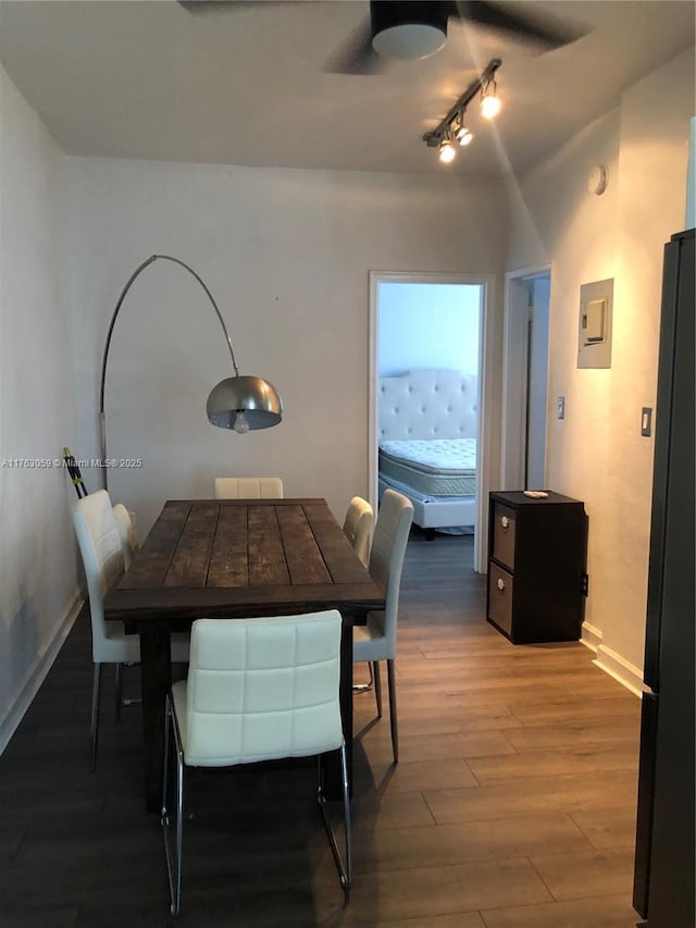 dining space featuring wood finished floors and baseboards