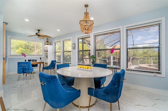 dining space with recessed lighting, marble finish floor, ceiling fan with notable chandelier, and baseboards