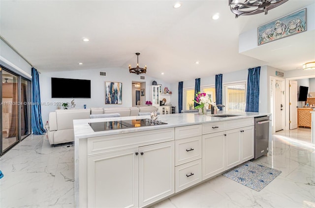 kitchen featuring black electric stovetop, a chandelier, open floor plan, marble finish floor, and a sink