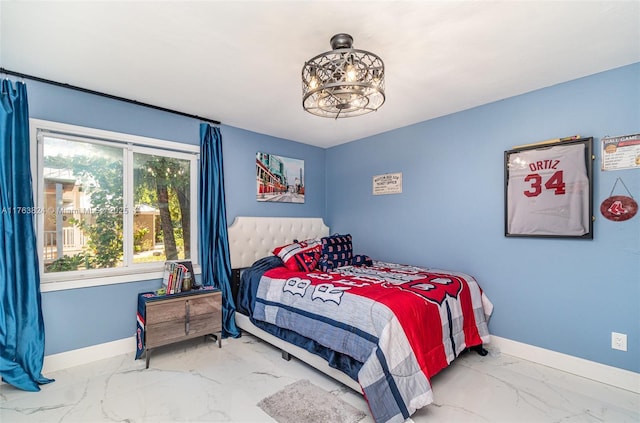 bedroom featuring marble finish floor and baseboards