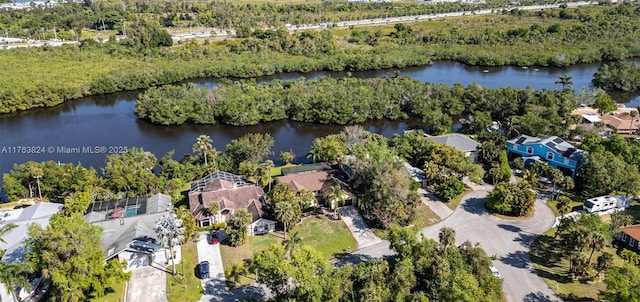 drone / aerial view featuring a forest view and a water view