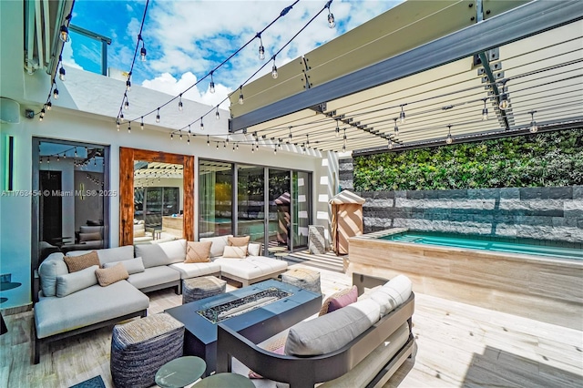 wooden terrace with an outdoor living space with a fire pit and a jacuzzi