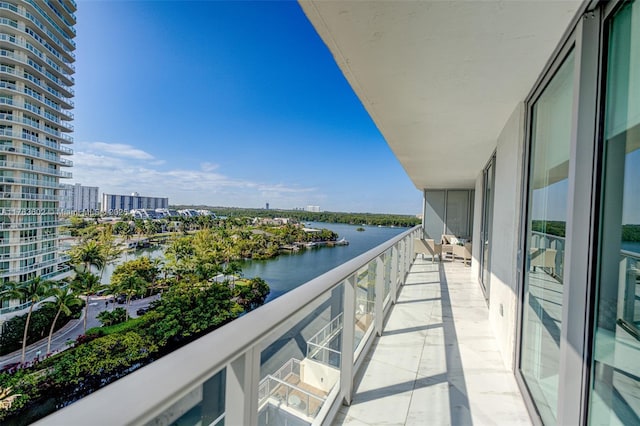 balcony with a water view and a view of city