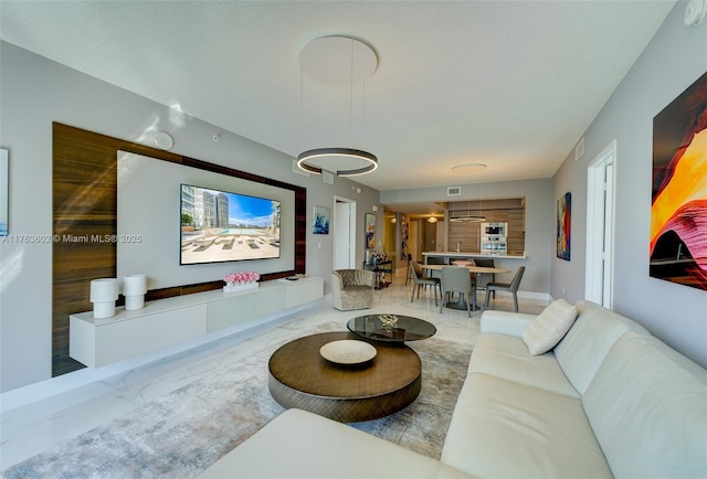 living area featuring marble finish floor