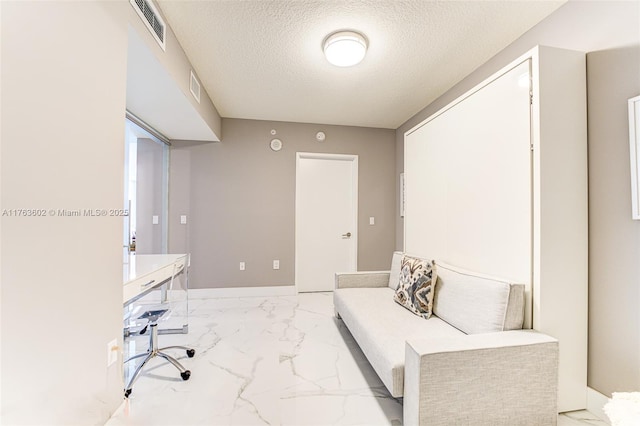 office area with visible vents, a textured ceiling, and marble finish floor