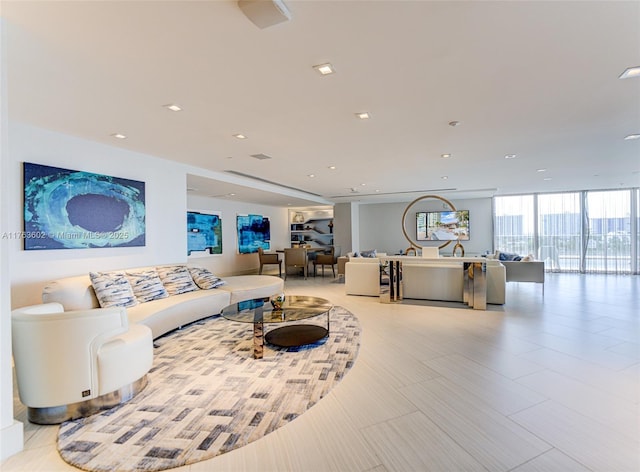 living area with recessed lighting and floor to ceiling windows