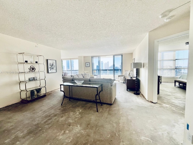 living area with a textured ceiling and concrete flooring