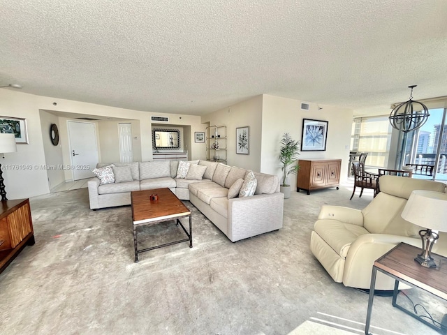 living room featuring visible vents, a textured ceiling, and an inviting chandelier