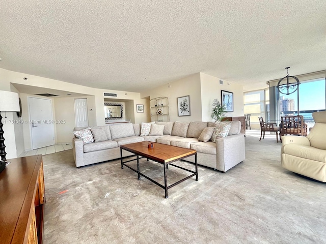 living area with visible vents, a textured ceiling, and concrete flooring