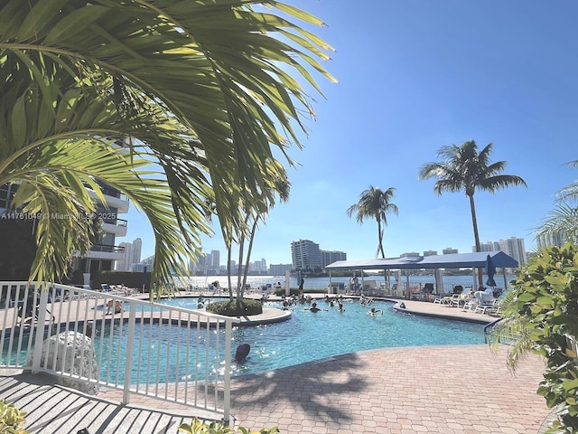 pool with a city view and a patio