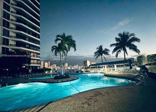 pool with a view of city and a patio