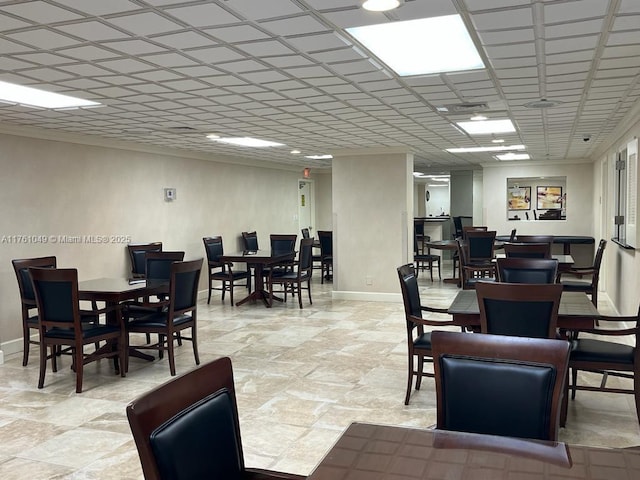 dining space with visible vents, baseboards, and a drop ceiling