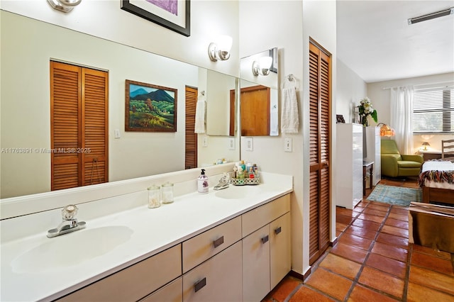 full bath featuring a sink, a closet, visible vents, and double vanity