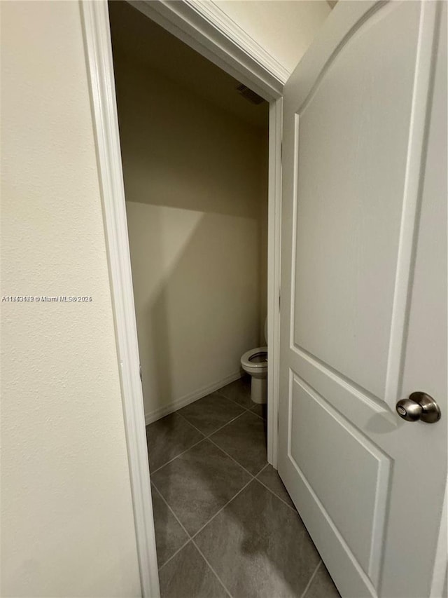 bathroom with tile patterned flooring and toilet