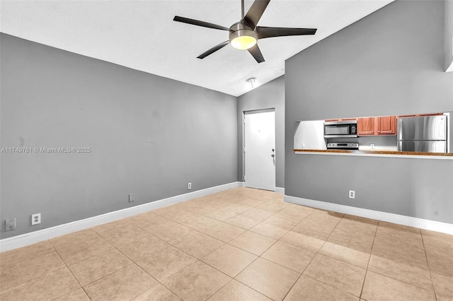 unfurnished room with light tile patterned flooring, high vaulted ceiling, baseboards, and a ceiling fan