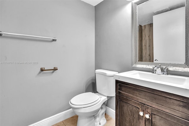 bathroom with vanity, tile patterned floors, toilet, and baseboards