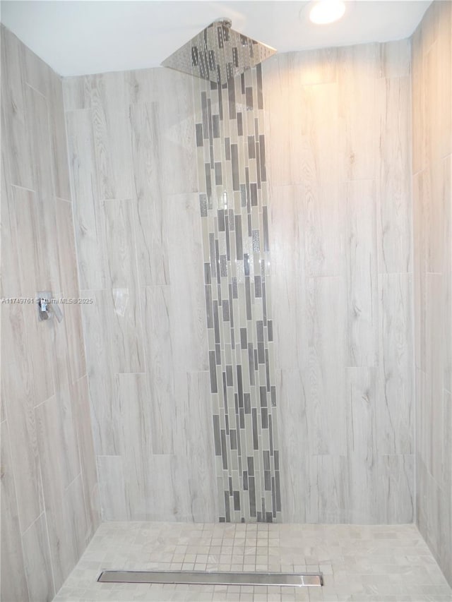 full bathroom with tiled shower