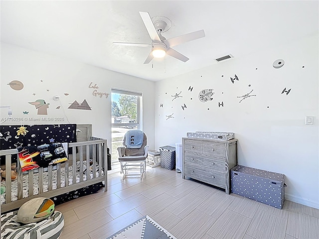 bedroom with a ceiling fan, visible vents, and baseboards