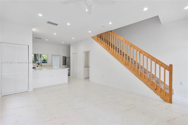 living area featuring stairway, visible vents, baseboards, recessed lighting, and marble finish floor