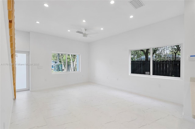 spare room featuring recessed lighting, visible vents, marble finish floor, and baseboards