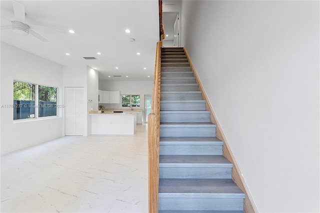 stairway with recessed lighting, visible vents, and ceiling fan