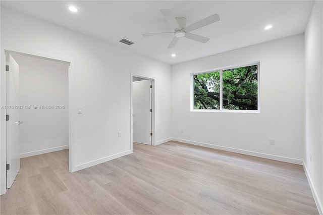 unfurnished bedroom featuring baseboards, visible vents, recessed lighting, a spacious closet, and light wood-type flooring