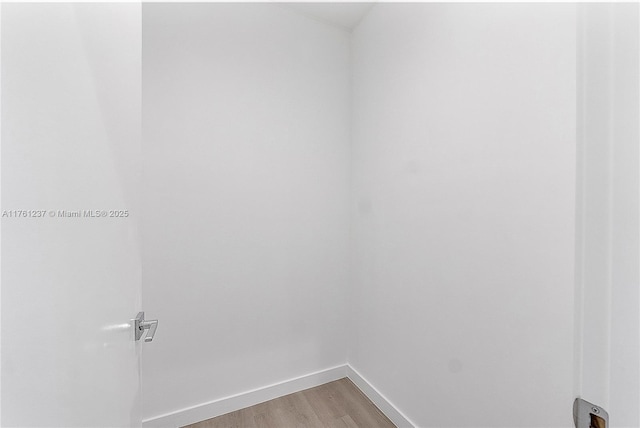 unfurnished room with light wood-style flooring and baseboards