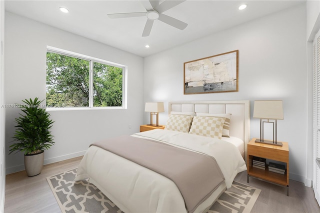 bedroom with recessed lighting, baseboards, and light wood finished floors