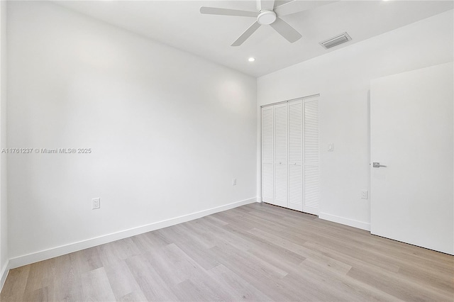 unfurnished bedroom featuring visible vents, baseboards, recessed lighting, light wood-style floors, and a closet