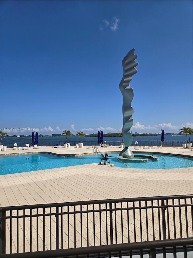 pool with a patio and a water slide