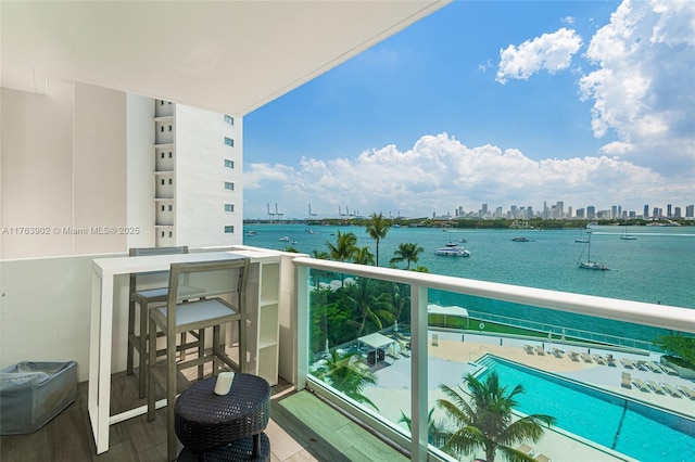 balcony with a view of city and a water view