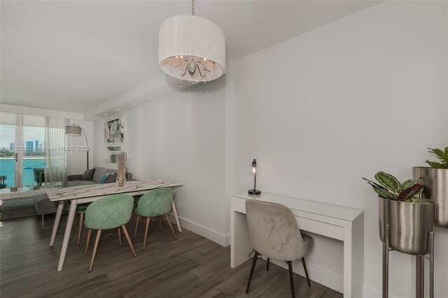 dining area featuring wood finished floors and baseboards