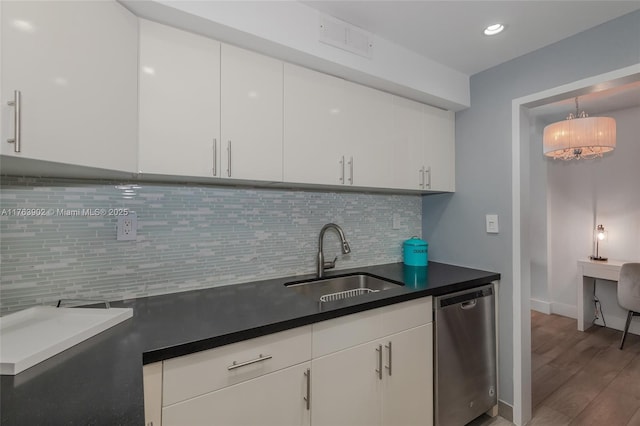 kitchen with visible vents, dishwasher, white cabinetry, and a sink